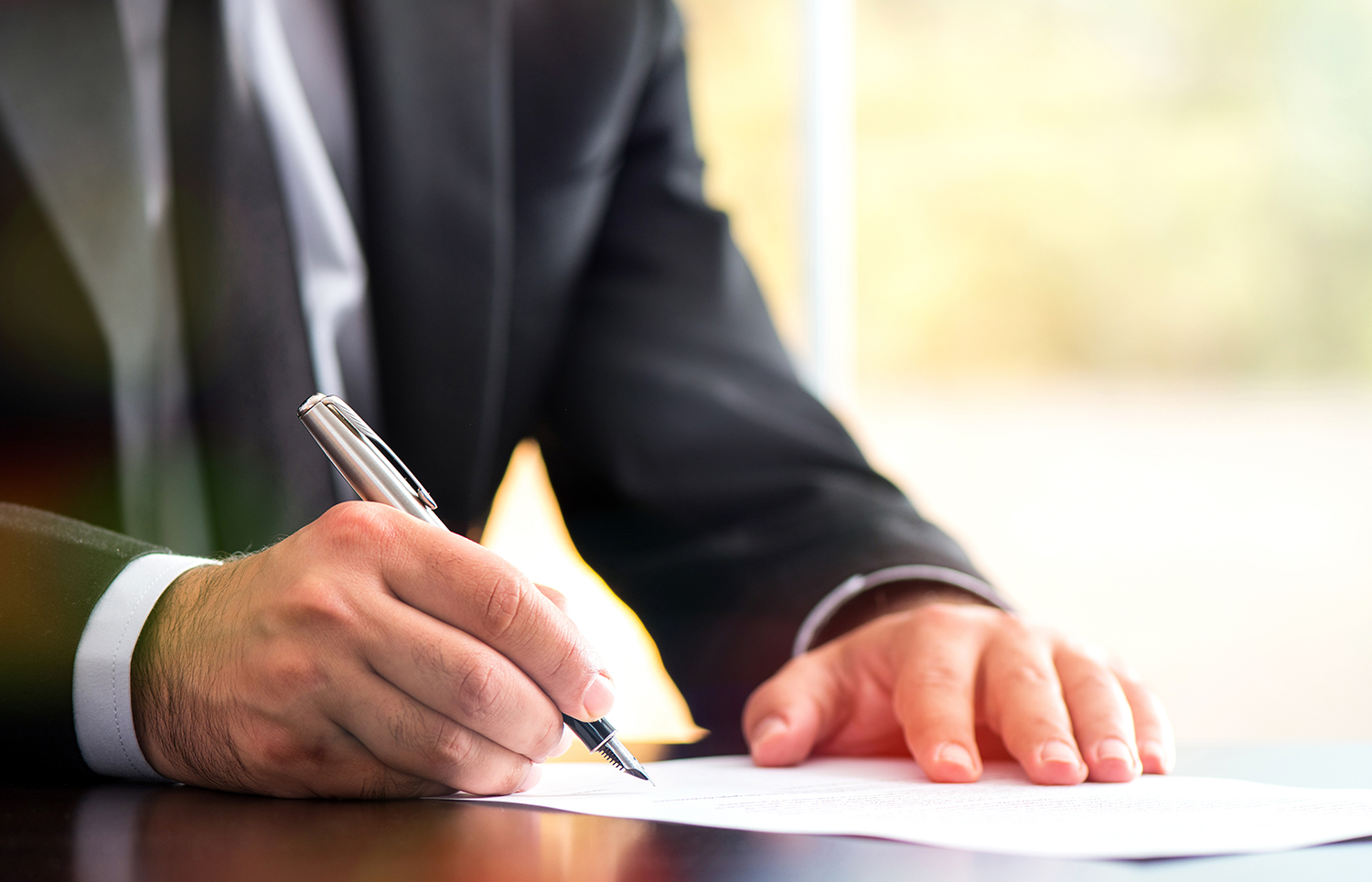 Businessman Is Signing A Legal Document In Office